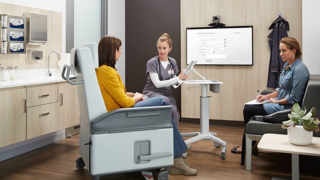 Doctor consultation room with wall display and telehealth cart