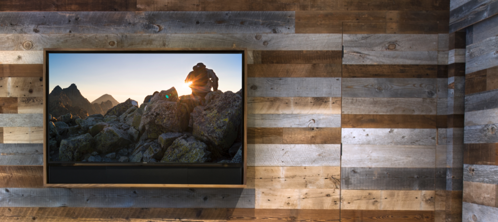 Frame-style TV mounted on a reclaimed wood wall